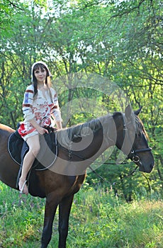 Girl in an ancient russian attire riding a horse