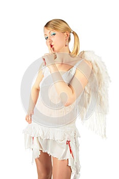 Girl in angel's costume has put finger to lips