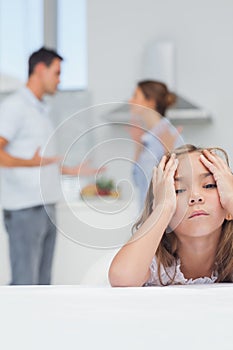 Girl annoyed while listening to parents quarreling