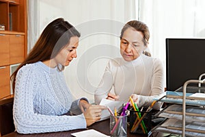 Girl answering questions of employee with laptop