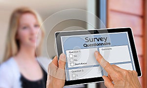 Girl answering survey questionnaire interview on tablet photo