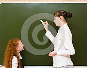 Girl answers questions of teachers near a school board