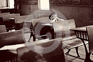 Girl at antique school desk