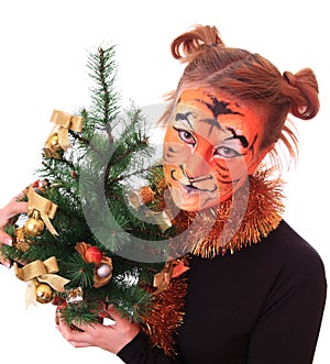 Girl in appearance a tiger with a new-year tree.