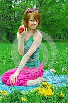 Girl with apple on coverlet photo