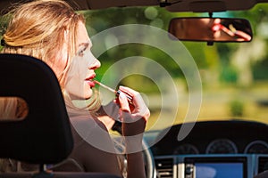 Girl apply make up while driving car