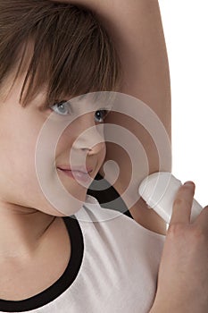 Girl applying deodorant on armpit