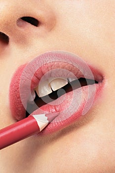 Girl applying lip liner