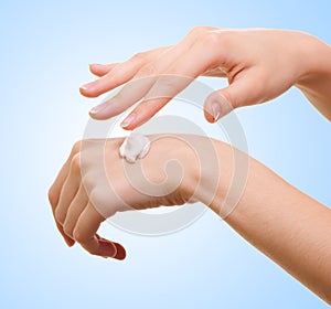 Girl applying some white lotion on her hand