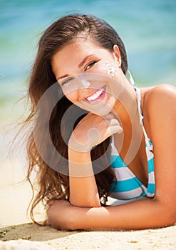 Girl applying Sun Tan Cream