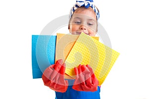 Girl in apron and gloves holding dusters