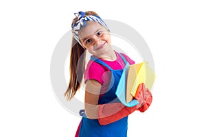 Girl in apron and gloves holding dusters