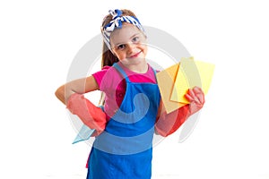 Girl in apron and gloves holding dusters