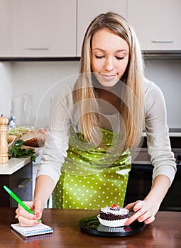 Girl in apron weighing cakes