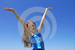 Girl with arms standing on Meadow