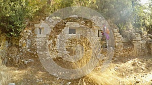 Girl around ruins of a Roman burials or storage facilities, two thousand-year-old city of Olympos Lycia, Lycian trail, Marcus Aure