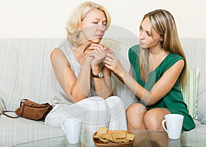 Girl asking for forgiveness from her mother. photo