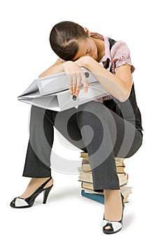 Girl asleep sitting on the books