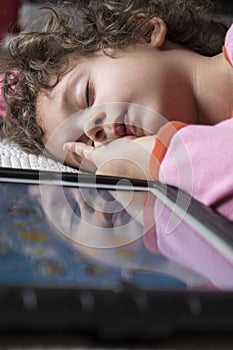 Girl asleep with tablet