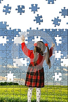 The girl assemble big puzzle