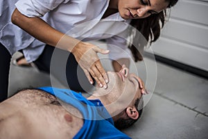 Girl assisting an unconscious man