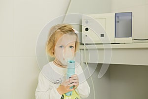 Girl with asthma inhaler.