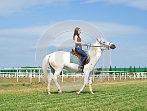 Girl astride a horse on a hippodrome