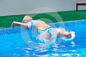 Girl athlete jumping into water