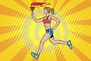 The girl athlete torchbearer sports fire summer games photo