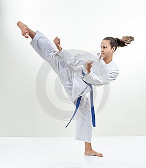 Girl athlete is training kick leg