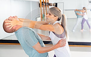 Girl attacking eyes of male partner during self-defense workout