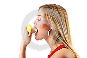 Girl attempts to eat a sour lemon