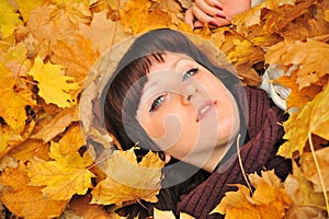 The girl in autumn leaves