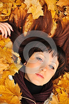 The girl in autumn leaves