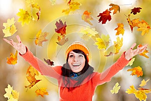 Girl in autumn orange hat with outstretched arm.