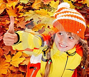 Girl in autumn orange hat with thumb up.