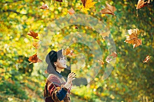 Girl in autumn orange leaves. Autumn leaves falling on happy young woman in forest. Fall concept. Fall. Autumn girl