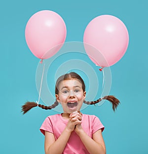 Girl on background of bright blue wall