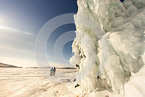 The girl on the background of the ice wall. Baikal, Russia