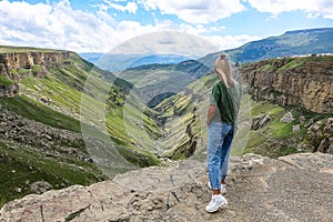 A girl on the background of the Khunzakh valley, Khunzakh waterfalls, Dagestan 2021