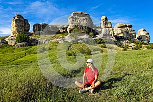 A girl on the background of a picturesque view of the Bakhchisarai sphinxes in summer. Bakhchisarai. May 2021. Crimea.