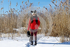 Girl on a background of a winter landscape.