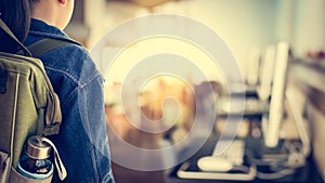 Girl with backpack entering to computer classroom. photo