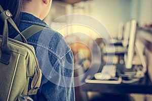 Girl with backpack entering to computer classroom. photo