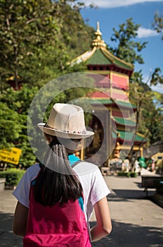 Girl with backpack entering to Quan Yin Shrine.