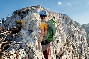 A girl with a backpack on a hike. adventure in the mountains. hiking with a backpack. girl with a backpack in the high mountains.