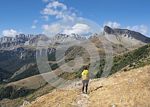 Girl with backpack hiking in the Hecho Valley, Western Valleys Natural Park, Huesca. photo