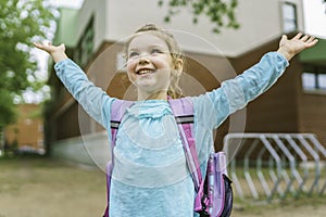 girl with backpack is ready for her first day of school.