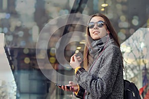 Girl with a backpack is traveling around the city