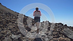 Girl with a backpack up the mountain